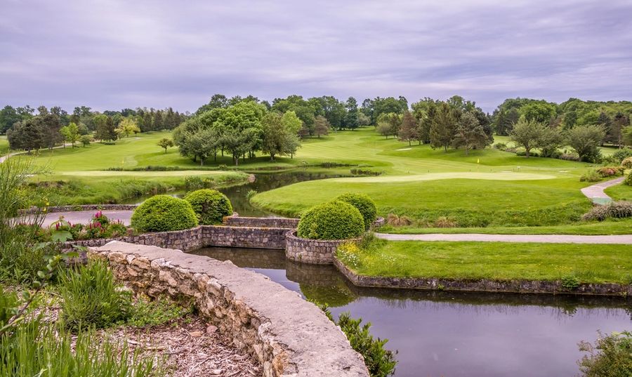 Stone bridge over a water feature on a golf course